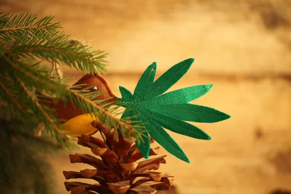 handmade toy cannabis leaf in the bird\'s beak. Cannabis marijuana new year product recreation