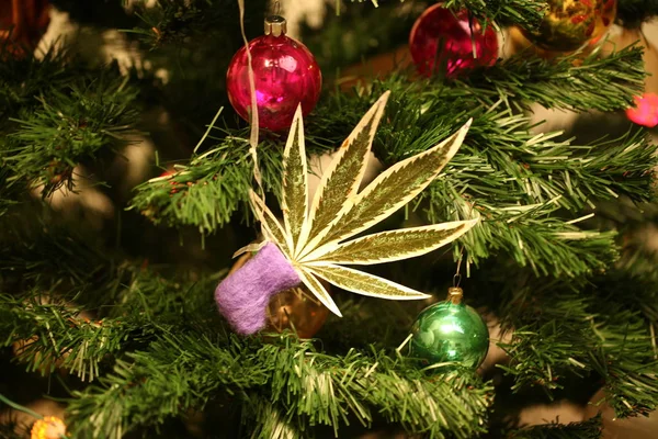 handmade toy on the Christmas tree. cannabis leaf marijuana new year product recreation