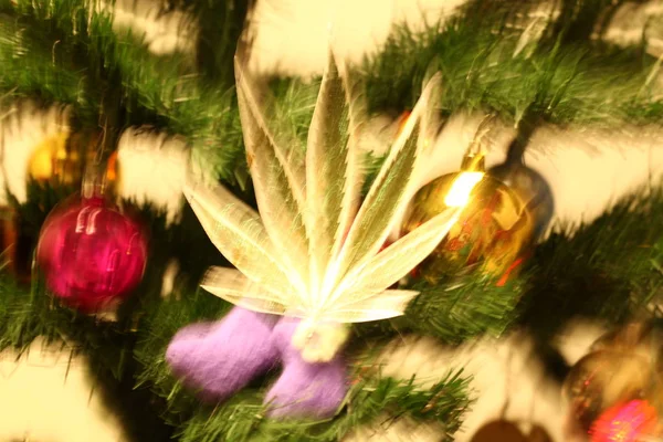handmade toy on the Christmas tree. cannabis leaf marijuana new year product recreation