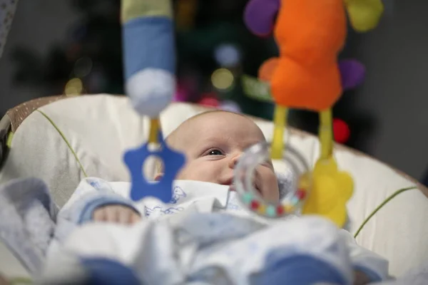 Newborn Funny Baby Lies Playing Toys Cradle Christmas Tree — Stock Photo, Image
