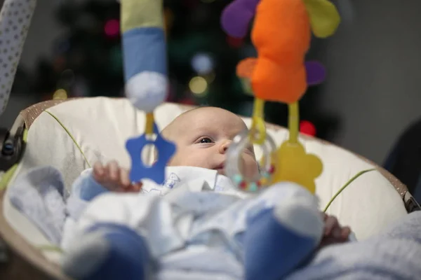 Newborn Funny Baby Lies Playing Toys Cradle Christmas Tree — Stock Photo, Image