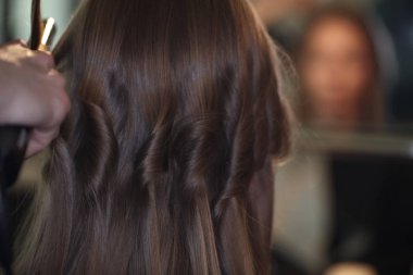 Kadının baş kıvırmak üzerinde salonda saç ustaları oluşturma