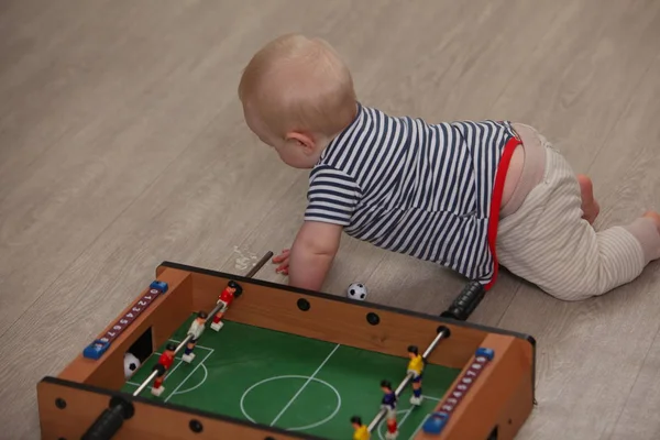 cute liitle boy playing table soccer