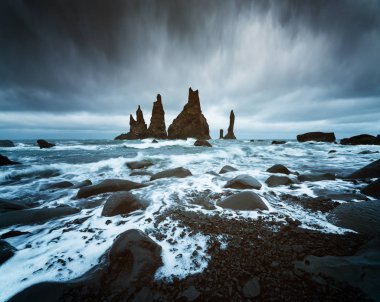 Trolls fingers. Reynisdrangar cliffs near the Vik town. Sullen landscape with the Atlantic Ocean. Tourist attraction of Iceland clipart