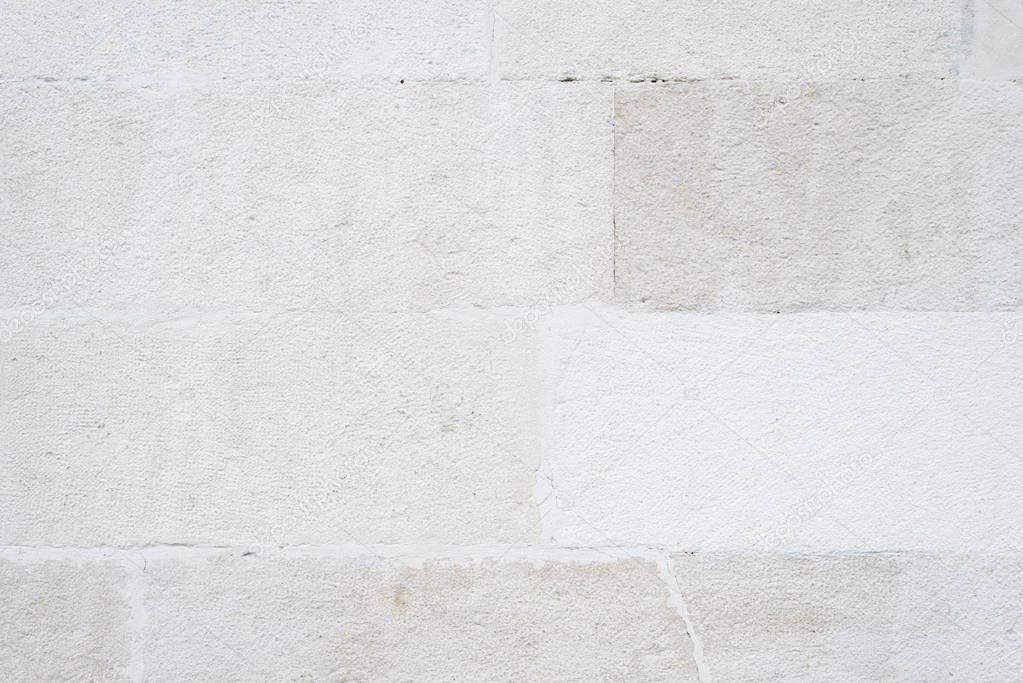 Texture of the wall of the old house. Masonry of white brick. Beige background for design