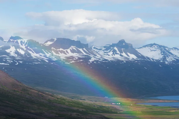 Summer landscape with a rainbow in the mountains. Picturesque valley in Iceland