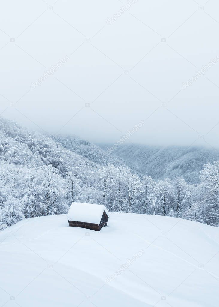 Lonely snowy house in the mountains