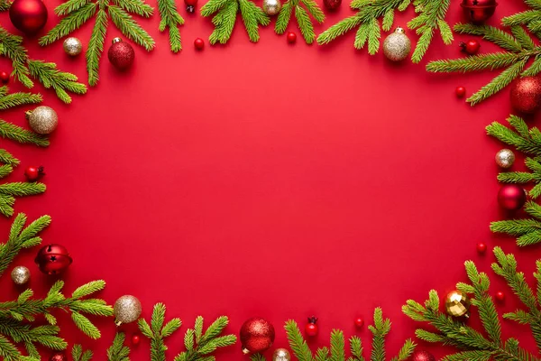 Red christmas background with oval frame. Happy holidays border with copy space for festive text. Top view, flat lay