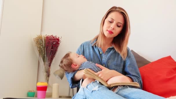 Woman Holding Hands Sleepy Son Reading Book — Stock Video