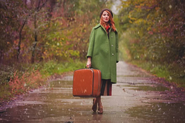 Young redhead girl in hat and coat at outdoor — Stock Photo, Image