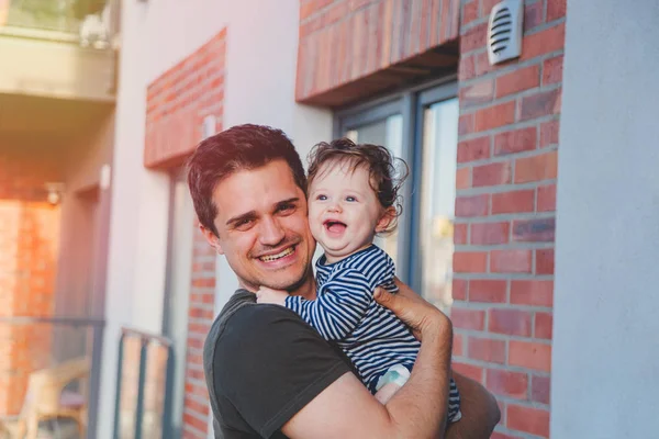 Young father with a child standing on balcony — Stock Photo, Image