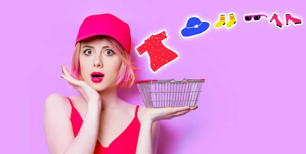 Surprised young woman with shopping basket — Stock Photo, Image