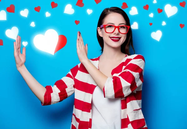 Woman on the blue background with hearts — Stock Photo, Image