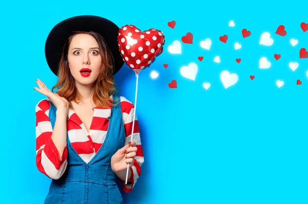 Surprised woman with heart shape toy with hearts — Stock Photo, Image