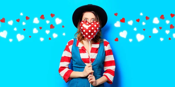 Surprised woman with heart shape toy with hearts — Stock Photo, Image