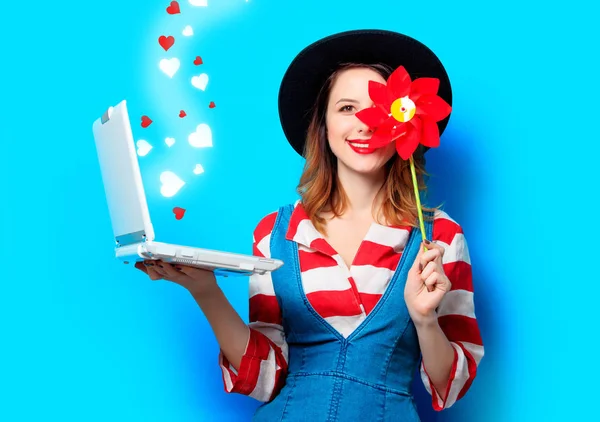 Femme avec ordinateur portable et roue à dents avec des cœurs — Photo