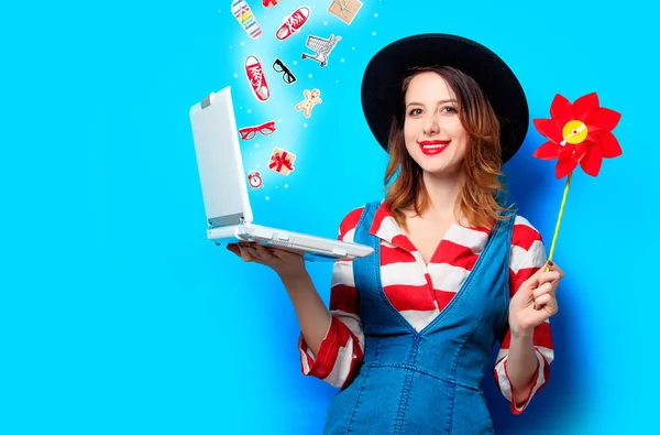 Mujer con portátil y molinete y con regalos —  Fotos de Stock