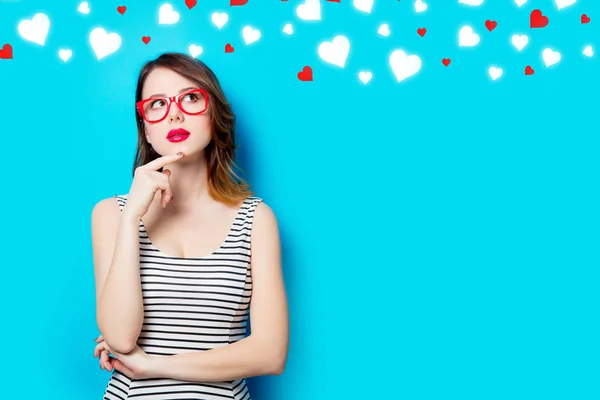 Young woman in glasses and abstract hearts — Stock Photo, Image
