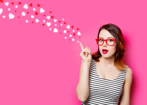 Young woman in glasses and abstract hearts — Stock Photo, Image