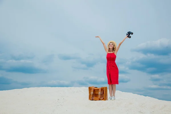 Mujer en vestido rojo con maleta y binoculares —  Fotos de Stock