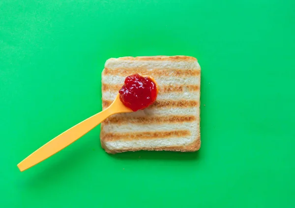 Slice of toast bread and tea spoon with jam — Stock Photo, Image