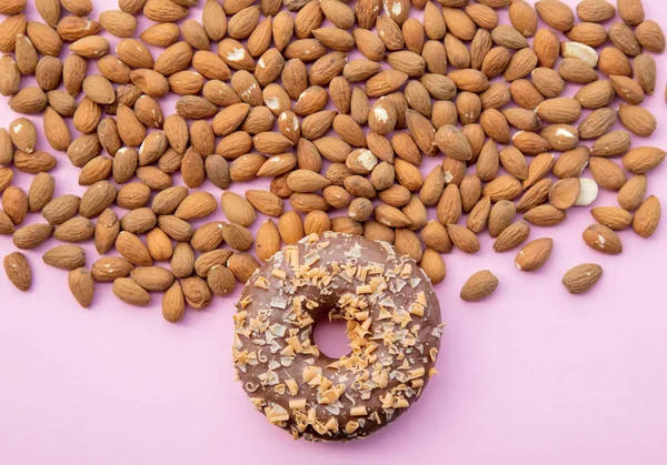 A lot of almonds and sweet donut — Stock Photo, Image