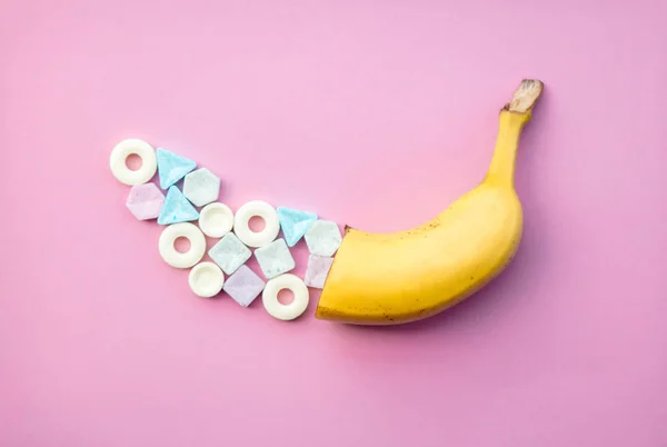 Colorful candies and yellow banana — Stock Photo, Image
