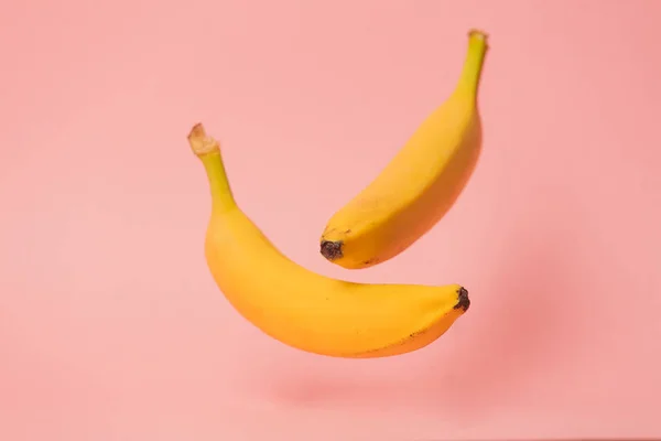 Two yellow bananas levitate in air — Stock Photo, Image