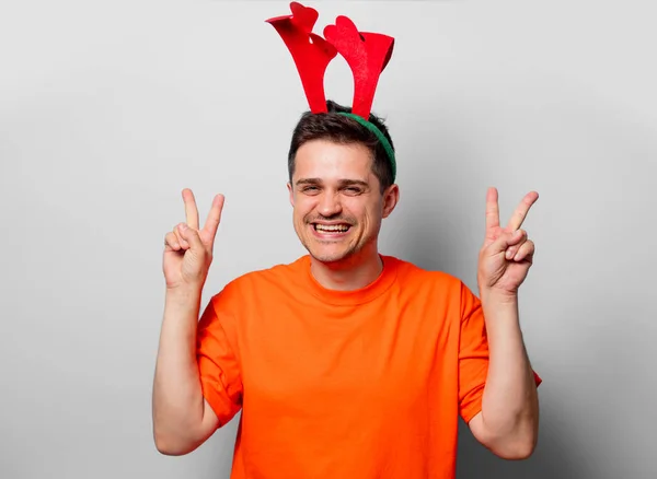 Young Handsome Man Orange Shirt Christmas Deer Horns Studio Image — Stock Photo, Image