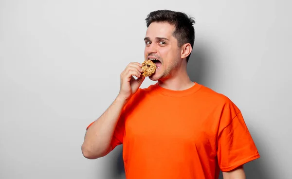 Jovem Bonitão Shirt Laranja Com Bolacha Imagem Estúdio Sobre Fundo — Fotografia de Stock