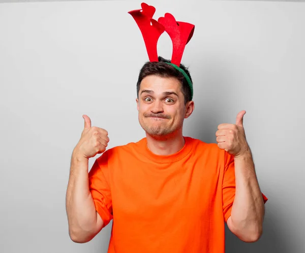 Young Handsome Man Orange Shirt Christmas Deer Horns Studio Image — Stock Photo, Image