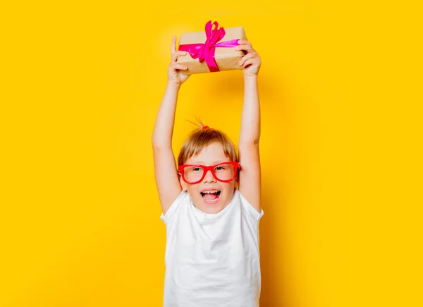 Дівчинка-малюк в окулярах з подарунковою коробкою — стокове фото