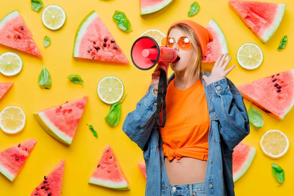 Girl with pink megaphone and fuits on background — Stock Photo, Image