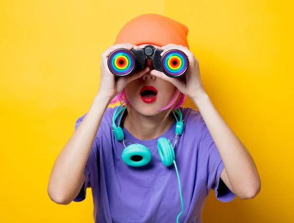 Young style girl in purple clothes with binoculars — Stock Photo, Image