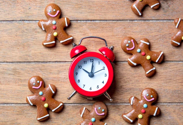 Christmas gingerbread man and alarm clock — Stock Photo, Image