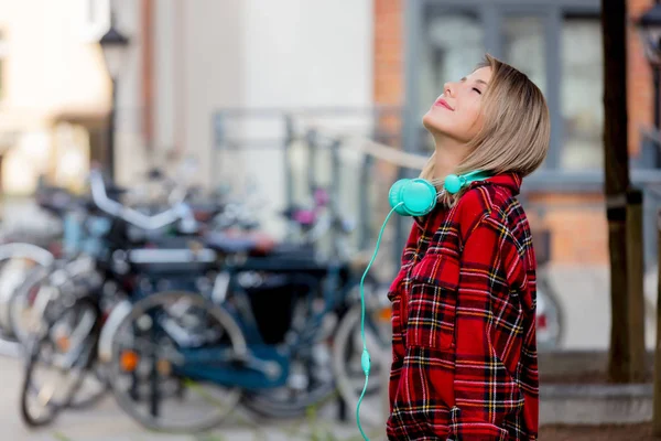 Young Blond Girl Headphones Outdoor Bicycles Blurred Background — Stock Photo, Image