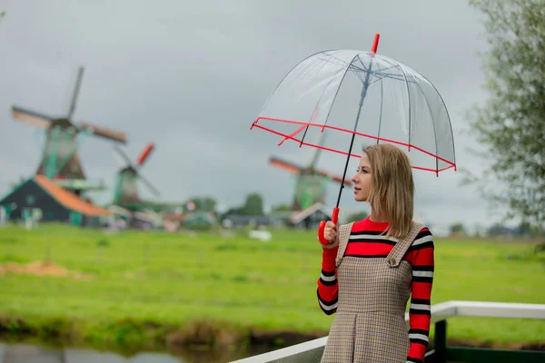 Ragazza stare su un ponte con mulini olandesi — Foto Stock