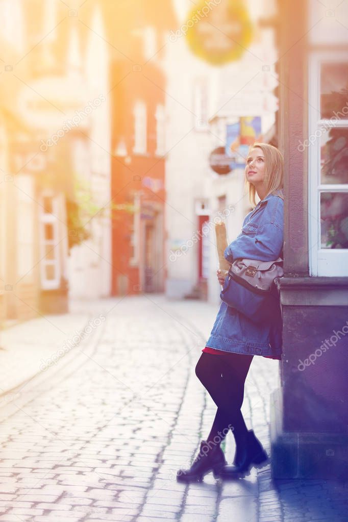 Young lady in jeans jacket on medieval street of Bremen