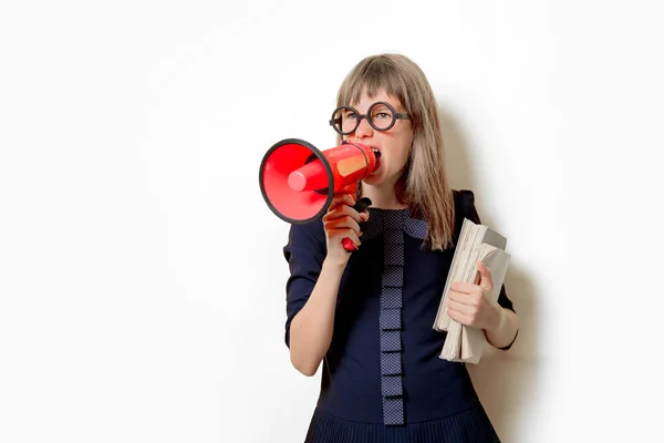 Nerd girl in glasses with books and megaphone — Stock Photo, Image