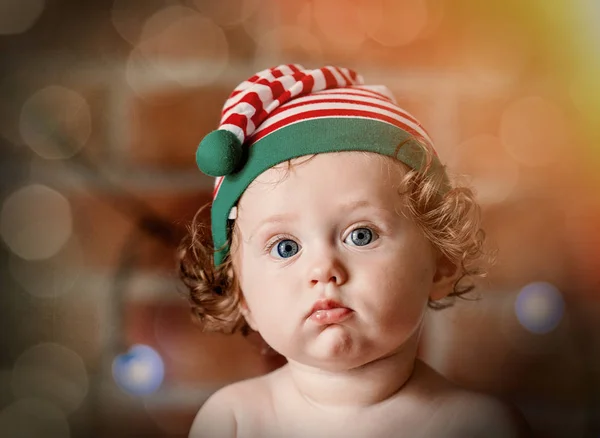Little baby boy in elf hat with fairy lights — Stock Photo, Image