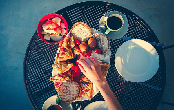 Traditional Crete food on breakfast, potatoes, cheese feta and bread with coffee or tea. Outdoor