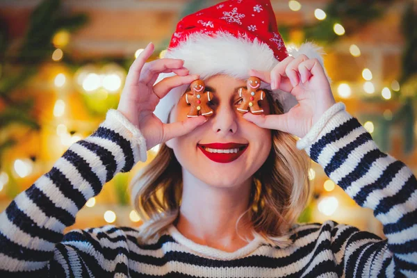 クッキーとクリスマスの照明と松の枝を持つ若い居心地の良い女性の肖像画 — ストック写真