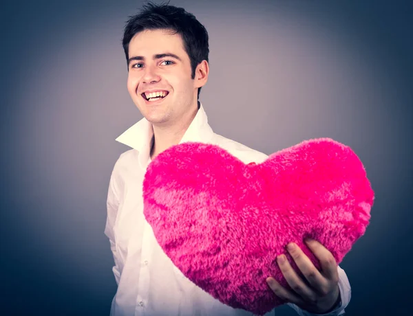 Hombre Joven Con Forma Corazón Juguete Sobre Fondo Gris —  Fotos de Stock