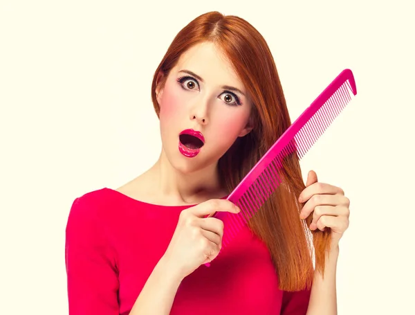 Funny redhead girl with big comb. — Stock Photo, Image