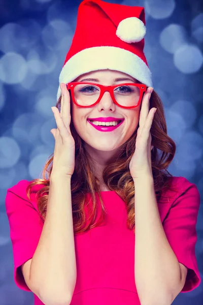 Ragazza in cappello di Natale e occhiali su sfondo grigio — Foto Stock