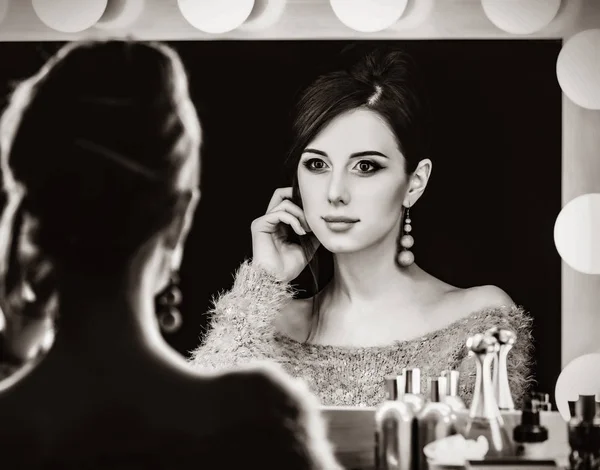 Portrait of a beautiful woman near a mirror — Stock Photo, Image