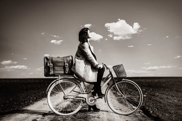 Portrait of a young woman with a bicycle and suitcase — Stock Photo, Image