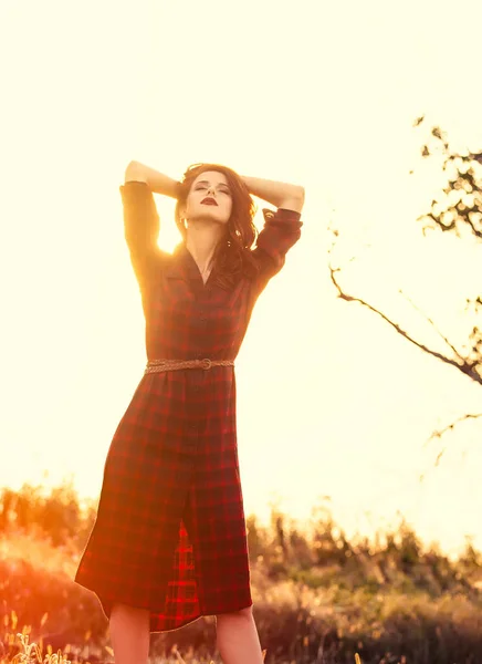 Beautiful girl in plaid dress — Stock Photo, Image