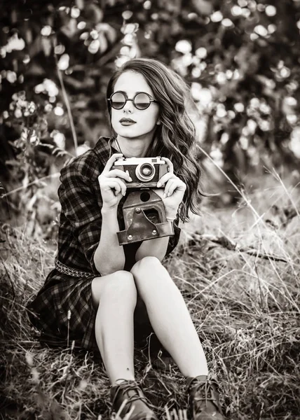 Girl in plaid dress retro camera and sunglasses — Stock Photo, Image