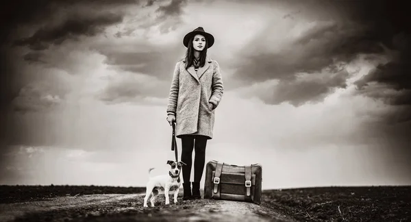 Portrait of young woman with suitcase and dog — Stock Photo, Image